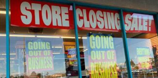 Store closing sale with going out of business signs.