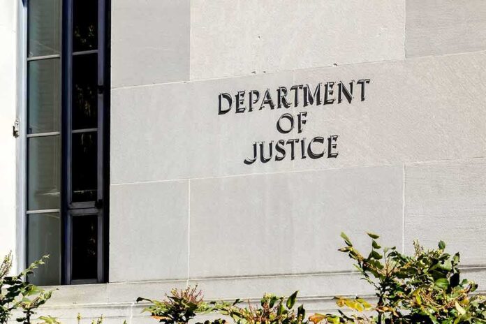 1664517481 featured image Department of Justice building exterior with window and plants.