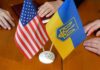 USA and Ukraine flags on a table