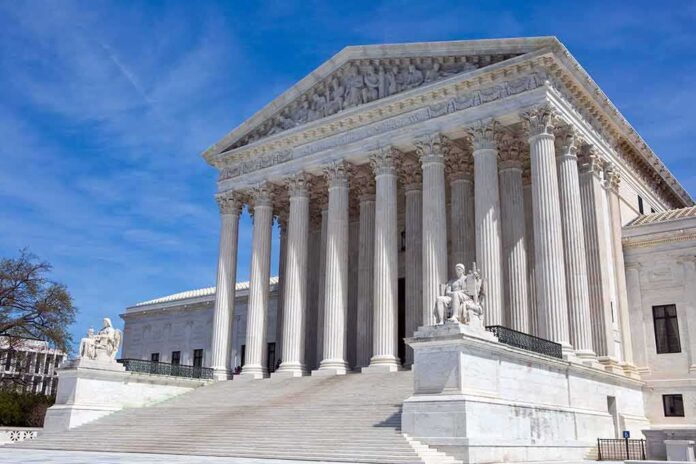 U.S. Supreme Court building with statues and columns.