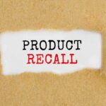 Text "Product Recall" on torn brown paper.