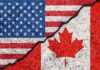 USA and Canada flags divided by a crack