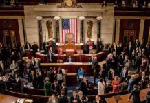 People gathering inside a government building legislative chamber