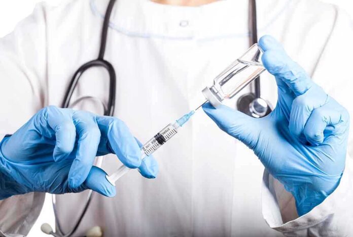 1310971853 featured image Doctor filling syringe with vaccine from vial.