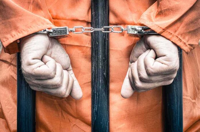 217094626 featured image Hands cuffed in front of prison bars