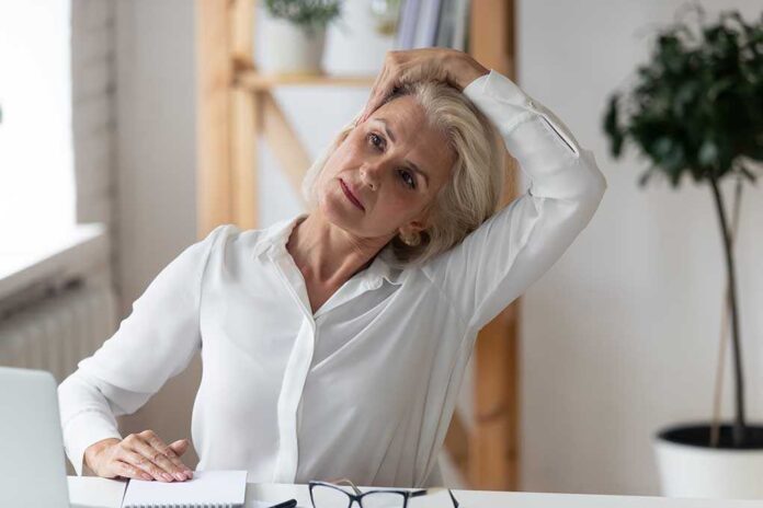 1619862568 featured image Woman stretching neck at a desk indoors