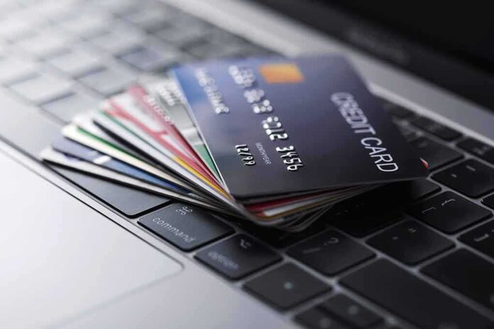 1722681316 featured image Stack of credit cards on a laptop keyboard.