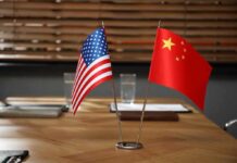 American and Chinese flags on a conference table.