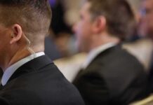 Security personnel with earpiece in a suit