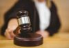 Judge using a gavel in courtroom