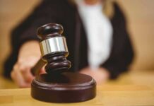 Judge using a gavel in courtroom