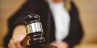 Judge using a gavel in courtroom