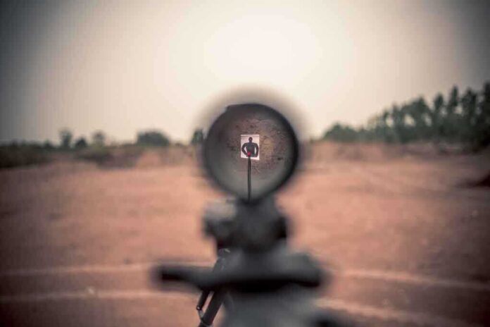 316081508 featured image Rifle scope aimed at a distant target outdoors