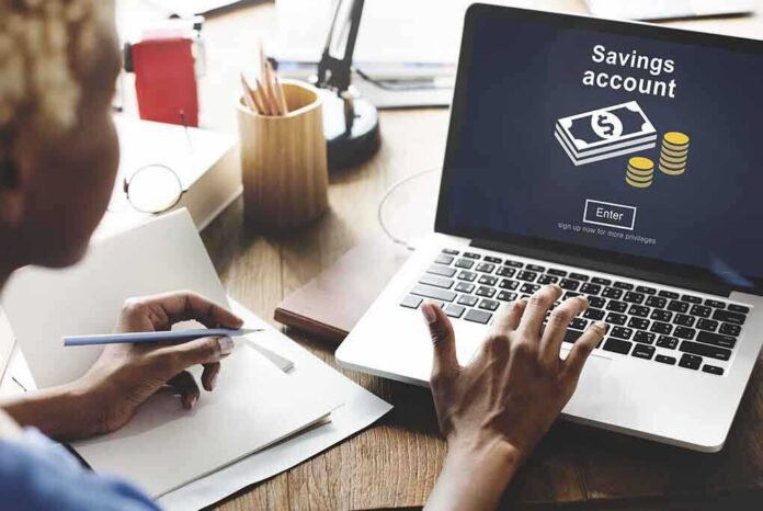 Person using laptop savings account application