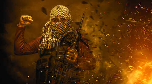 shutterstock_1401389099.jpg featured image Masked militant holding weapon against fiery background.
