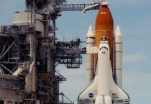 Space shuttle on launch pad with support structure