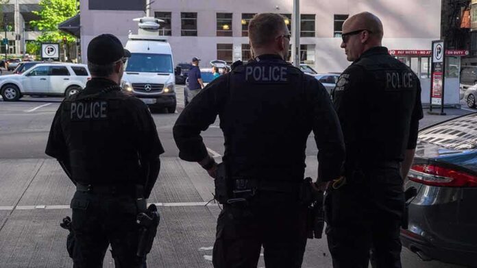 1386794081 featured image Three police officers standing on a city street