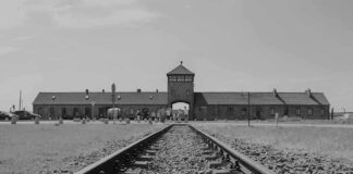 Railroad tracks leading to historical brick building gateway
