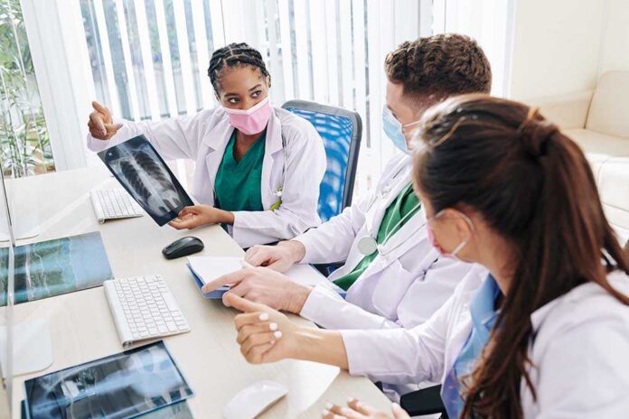 1779923279 featured image Doctors discussing chest X ray results at a workstation