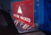 Warning sign System Hacked on laptop screen