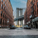 Photo With EXTREMIST Imam SHOCKS Mayoral Race Street view with bridge between two brick buildings