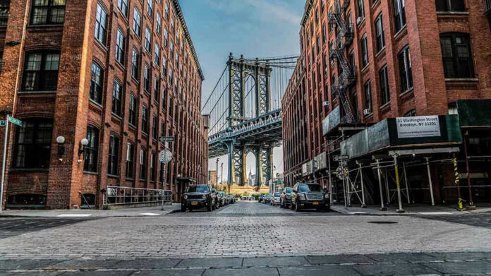 1071270287 Street view with bridge between two brick buildings