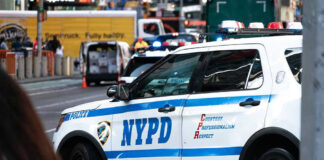 NYPD police car on a city street scene
