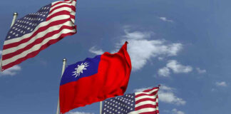 American and Taiwanese flags waving in the sky