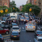 Police activity on a city street with emergency vehicles