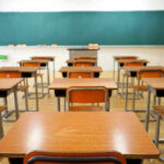 Empty classroom with desks and a chalkboard