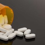 Spilled prescription bottle with white pills