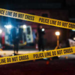 Blue City Bloody Weekend – Residents Turn to Trump Yellow police tape in front of crime scene.