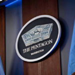 Shock Shift—Pentagon Dumps Chinese Nationals The Pentagon emblem between two flags.