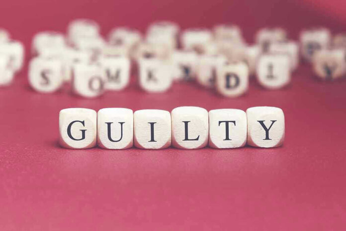 Dice spelling "GUILTY" on a red surface.