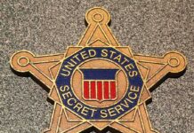 Golden badge of the United States Secret Service displayed on a surface