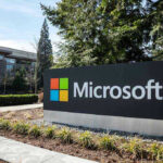 Microsoft Exec Office Stormed: Unbelievable Protest Move Microsoft sign with office buildings and trees.