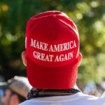 MAGA Hat Suspension Sparks National Uproar Person wearing a red Make America Great Again hat