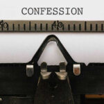 Typewriter with CONFESSION on paper