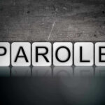 Blocks spelling PAROLE on grungy background.