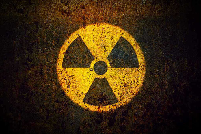 Yellow radiation warning symbol on rusty metal surface