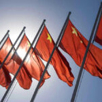 Red flags with yellow stars on flagpoles