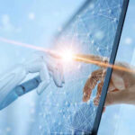 Robotic and human hands touching through a screen.