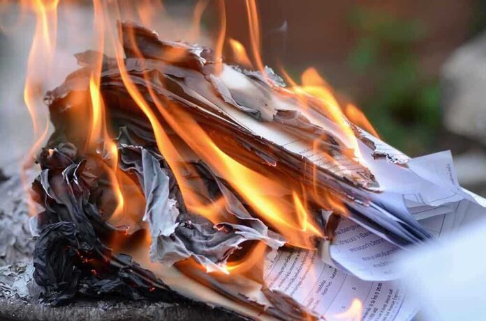 shutterstock_175638785.jpg Burning papers with flames and smoke rising