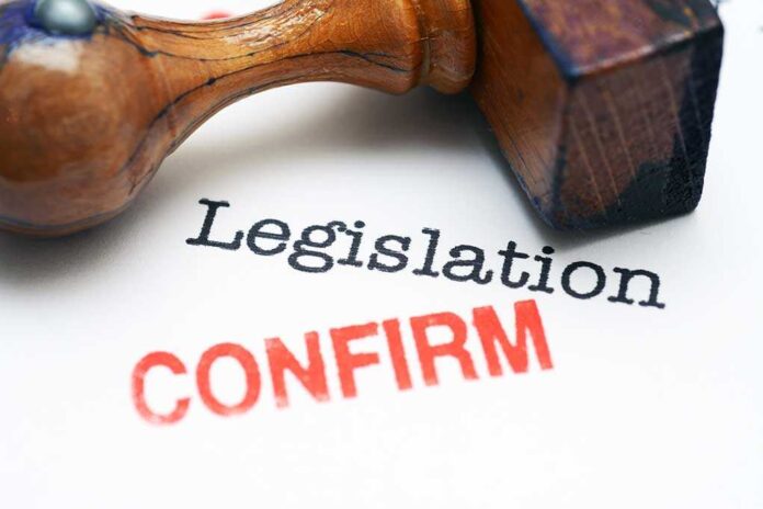 Rubber stamp on a document with the words Legislation and CONFIRM