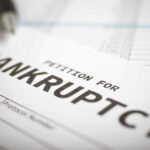 Petition for bankruptcy document with pen.