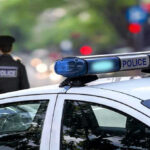 Stranger EXECUTES Innocent Man in His Own Yard Police car and officer on a city street.