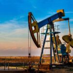 U.S. Claims 50 Million Barrels – TOTAL CONTROL An oil pump jack operating against a sunset backdrop
