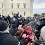 Police Retreat: Overwhelmed by Protesters A tense standoff between protesters and police at a demonstration