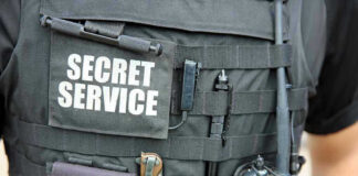 Secret Service vest with various tactical gear attached.