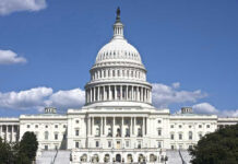 U.S. Capitol building against blue sky.